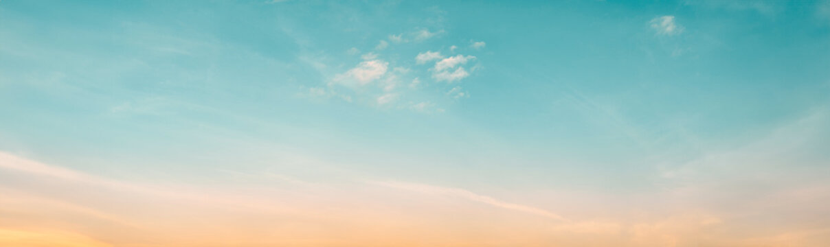 The clear teal blue sky with white clouds provides a bright and sunny background, enhancing the natural beauty of the landscape on this pleasant summer day