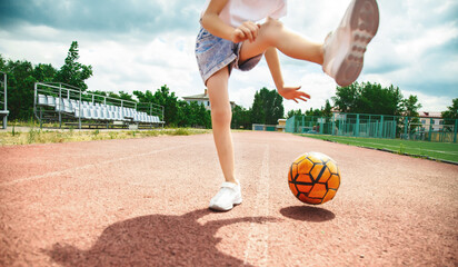 Close up photo young girl playing basketball- dribbling and lifting leg