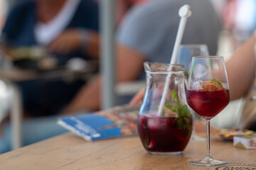 Refreshing beverages on a wooden table at an outdoor cafe during a sunny afternoon