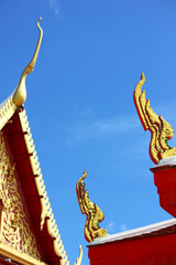 gold color gable apex hand craft Thai culture building temple decorating in coner of roof