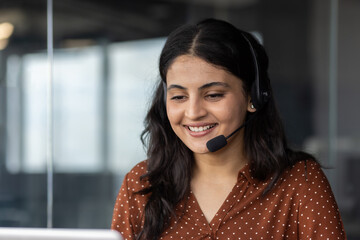 Young woman in office wearing headset engaged in customer service call smiling while communicating with clients providing assistance and support through phone showing, professionalism and dedication.