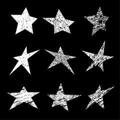 Grunge stars. Set of white grunge star. Vector illustration on a black background.