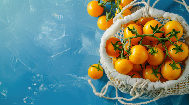 Fresh yellow tomatoes in the cotton string bag