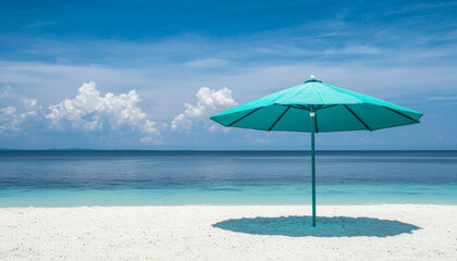 Fototapeta premium A serene beach scene featuring a turquoise umbrella casting a shadow on white sand, with calm waters and a blue sky.