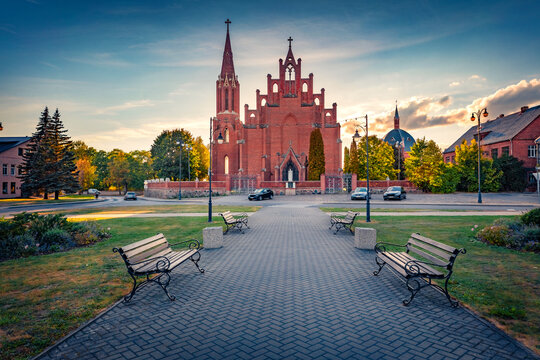 Beautiful evening view of red briks St. Matthew Apostle Catholic Churc h. Unbelievable summer cityscape of Rokiskis town, Latvia, Europe. Traveling concept background.