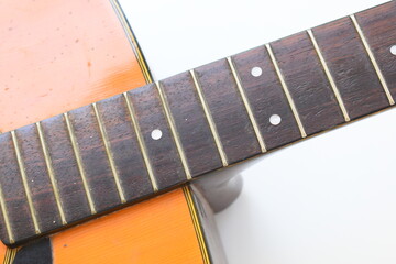 brown wood acoustic guitar isolated on white background