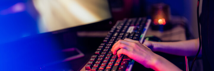 Close up of hands using keyboard for Online video game . © mojo_cp
