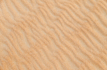 Sand with natural pattern. Beach sand background with natural wave pattern