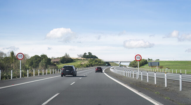 Driving on Waikato Expressway. 110 km/h road speed sign on the road side. New Zealand.