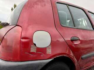 The gas tank cap does not match the color of the car. 
concept: purchasing spare parts on the secondary market