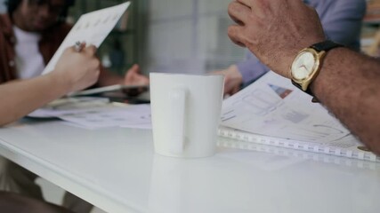 Businessman drinking coffee during meeting with colleagues - Powered by Adobe