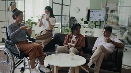 Multiracial team of colleagues having lunch at office