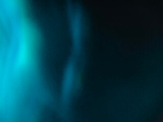 Blue bokeh light effect against a dark background. The speed of light creates beautiful compositions.