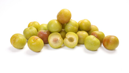 Ripe sweet small mini plum green maroon on white background