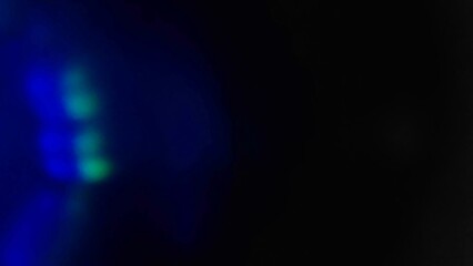 Blue bokeh light effect against a dark background. The speed of light creates beautiful compositions.