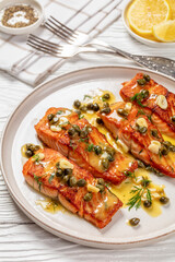 salmon piccata with lemon caper sauce on plate