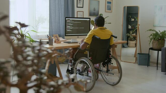 Remote worker with disability coding on computer at home