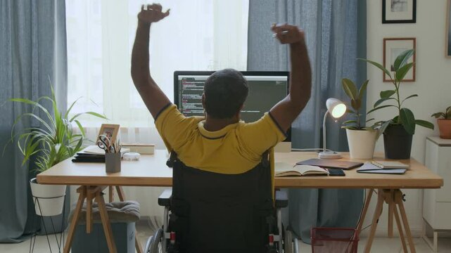 Remote worker in wheelchair resting after finishing online task