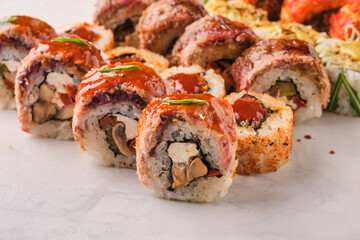 Delicious sushi rolls featuring creative ingredients and vibrant colors, served on a clean white surface, inviting culinary exploration