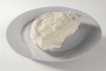 Plate with soft cheese, on white background