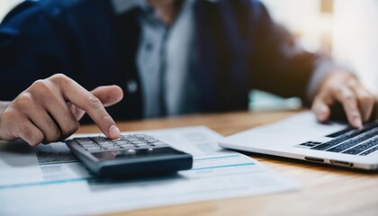 close up young man hand press on calculator to check and summary expense of home loan mortgage 