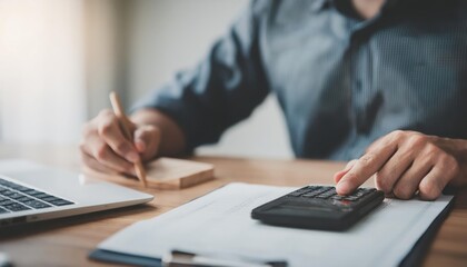 close up young man hand press on calculator to check and summary expense of home loan mortgage 