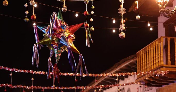A colorful pi&ntilde;ata hangs over a historic downtown street in Mazamitla, Jalisco, Mexico.
