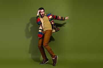 Photo of optimistic cheerful nice man wear trendy clothes have fun crazy dance isolated on khaki...