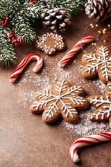 Fototapeta premium A table laden with numerous cookies, dusted with snow, adjacent to candy canes, and adorned with a Christmas decoration