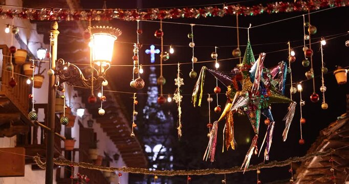 A colorful pi&ntilde;ata hangs over a historic downtown street in Mazamitla, Jalisco, Mexico.