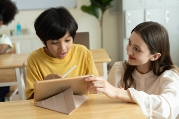 Teacher Guiding Student with Digital Learning in Diverse Classroom