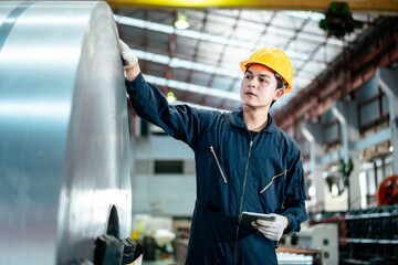 Worker in safety uniform together inspection check to quality controll roll of raw steel sheet in...