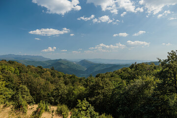 ampia vista panoramica su parte del bellissimo territorio naturale tra la collina e la montagna, sul confine tra Italia e Slovenia, di pomeriggio, in estate, con un cielo sereno