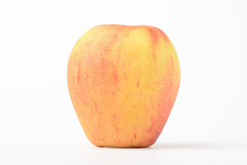 Fresh ripe apple with tiny water drops on white background