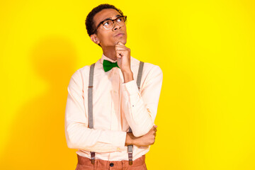 Portrait of attractive classy young man look empty space wear shirt bow tie isolated on yellow...