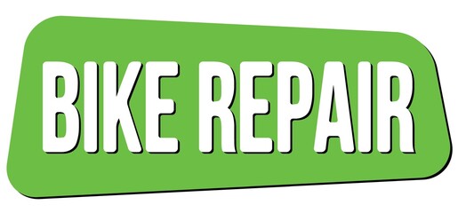 BIKE REPAIR text on green trapeze stamp sign.