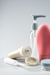 Variety of travel-sized containers displayed against a bright blue background