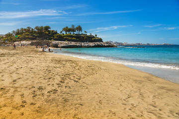 Fototapeta premium A breathtaking view of Playa Del Duque in Tenerife, where clear blue waters and soft golden sand meet