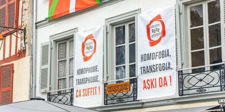 Collectif 2032 posters against homophobia and transphobia on a wall of a building in the center of Bayonne, France