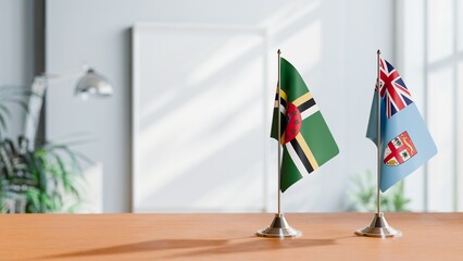 FLAGS OF DOMINICA AND FIJI ON TABLE