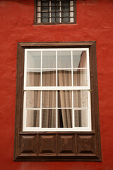 Ventana en fachada de edificio en color caldero.