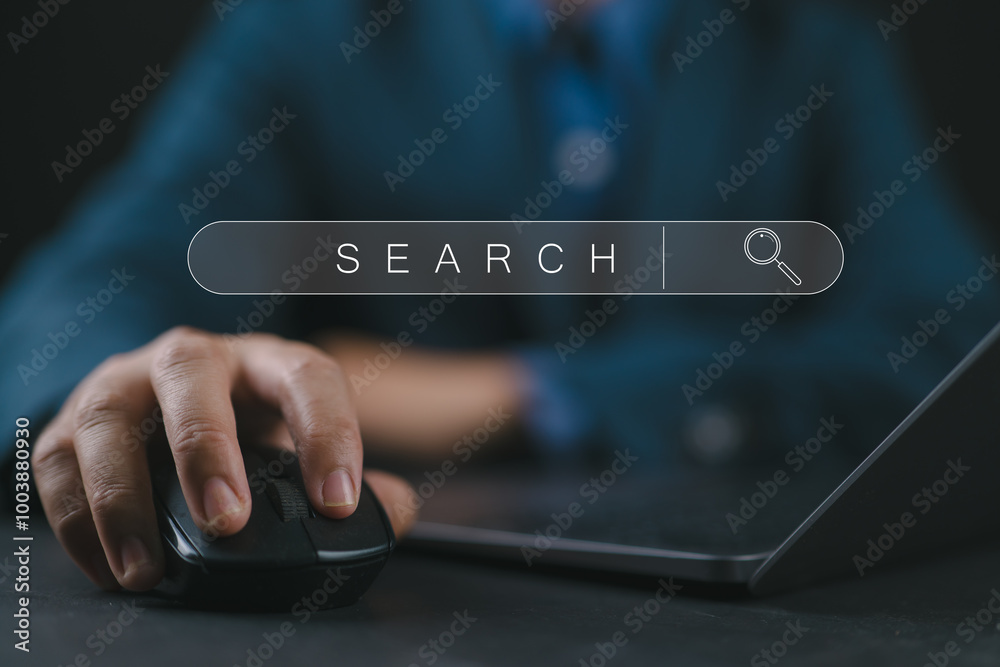 Leinwandbilder Businessman holding mouse and computer keyboard with search engine bar website on the table for searching information from internet , cloud computer by input optimization keyword concept.