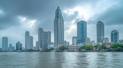 Obraz premium Skyline of modern Bangkok, Thailand. Majestic skyscrapers on the waterfront under the cloudy sky at twilight time.