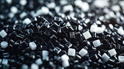 Obraz premium Black and white plastic pellets. A close-up of plastic pellets, commonly used in manufacturing.