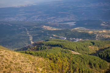 Fototapeta premium Dramatic cityscape panorama overlooking green hills