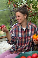 woman farmer picking tomatoes greenhouse