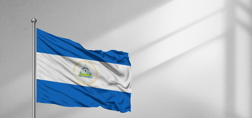 Nicaragua national flag cloth fabric waving on beautiful window light grey Background.