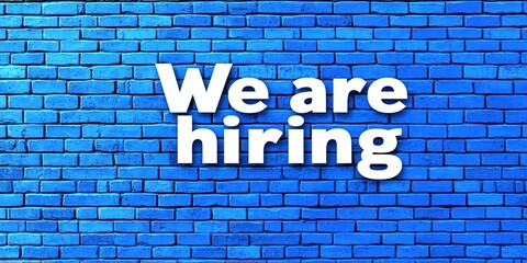 Obraz premium We are hiring text on the blue brick wall. Concept of employment. Generative Ai