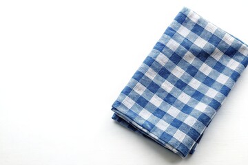 Kitchen towel made of natural blue linen on a white isolated background with shallow depth of field.