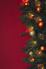 Christmas background with Christmas lights and fir toys. Red background.